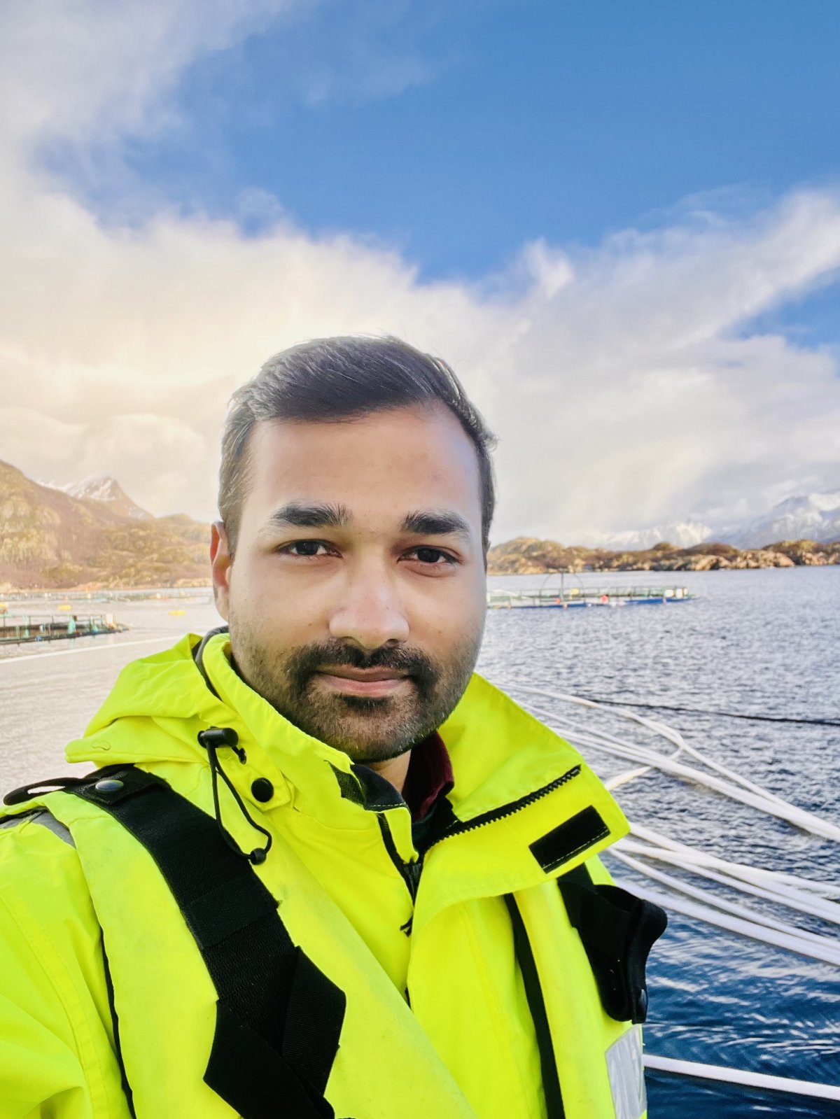 Man in yellow jacket on boat