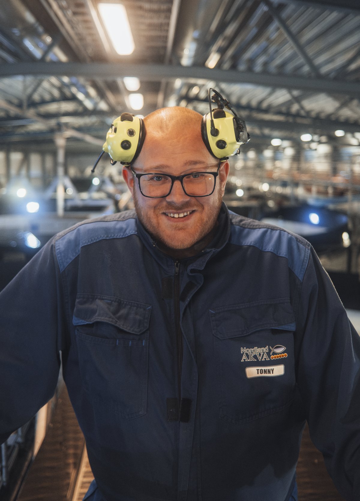 Man with glasses in factory setting